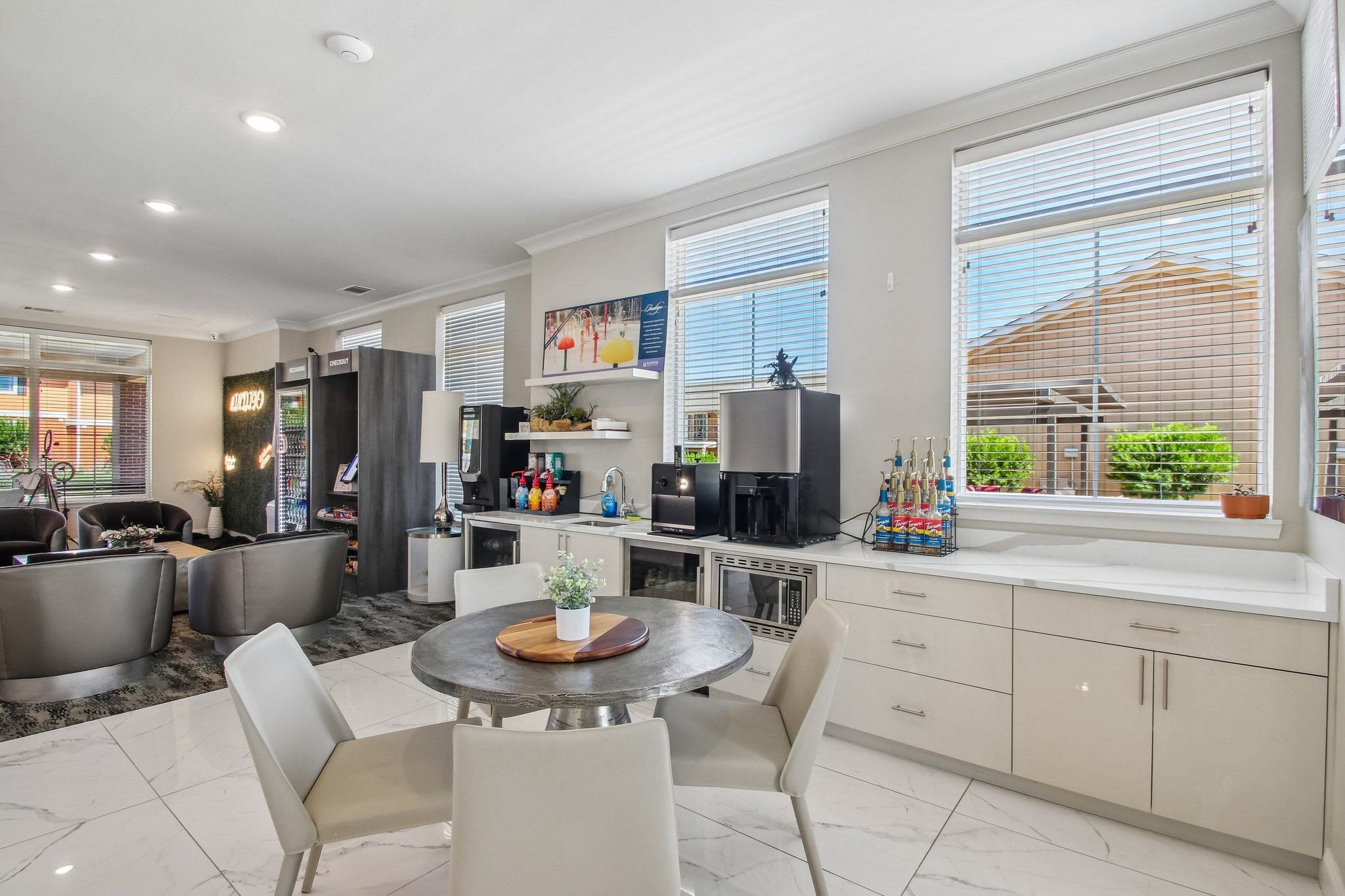 A modern kitchen with a dining table and chairs.